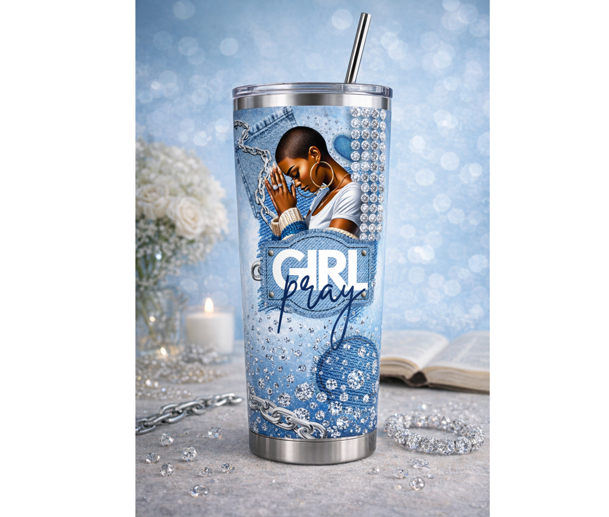 Tumbler with a design of a woman with a short hair cut praying, surrounded by flowers and candles, on a light blue background.