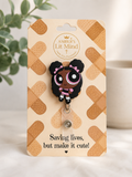 Amber's Lit Mind badge reel with cartoon character on a bandaid-themed card