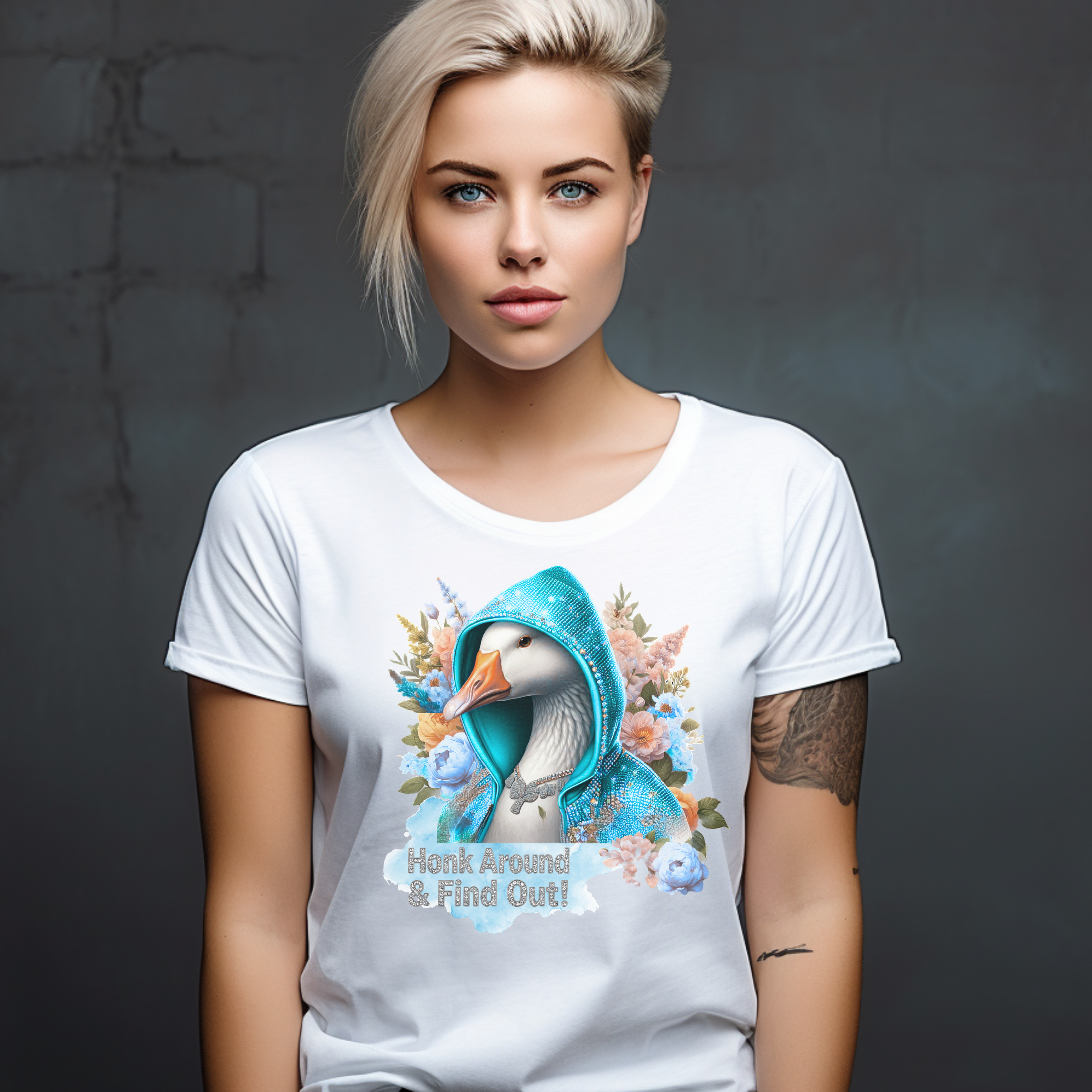 Woman wearing a white t-shirt with a cartoon duck in a blue hood design on a dark background