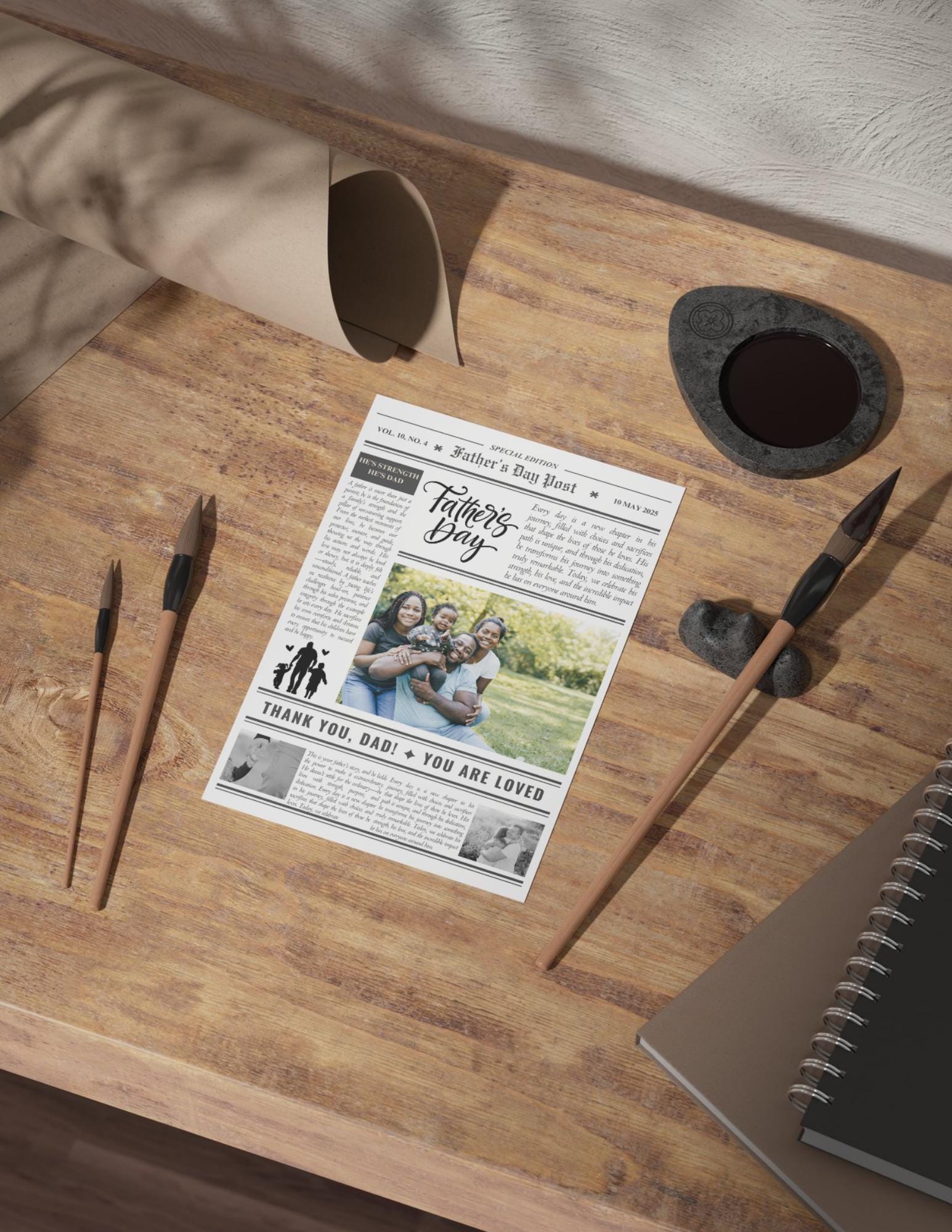 Newspaper with Father's Day message on a wooden table with decorative items.