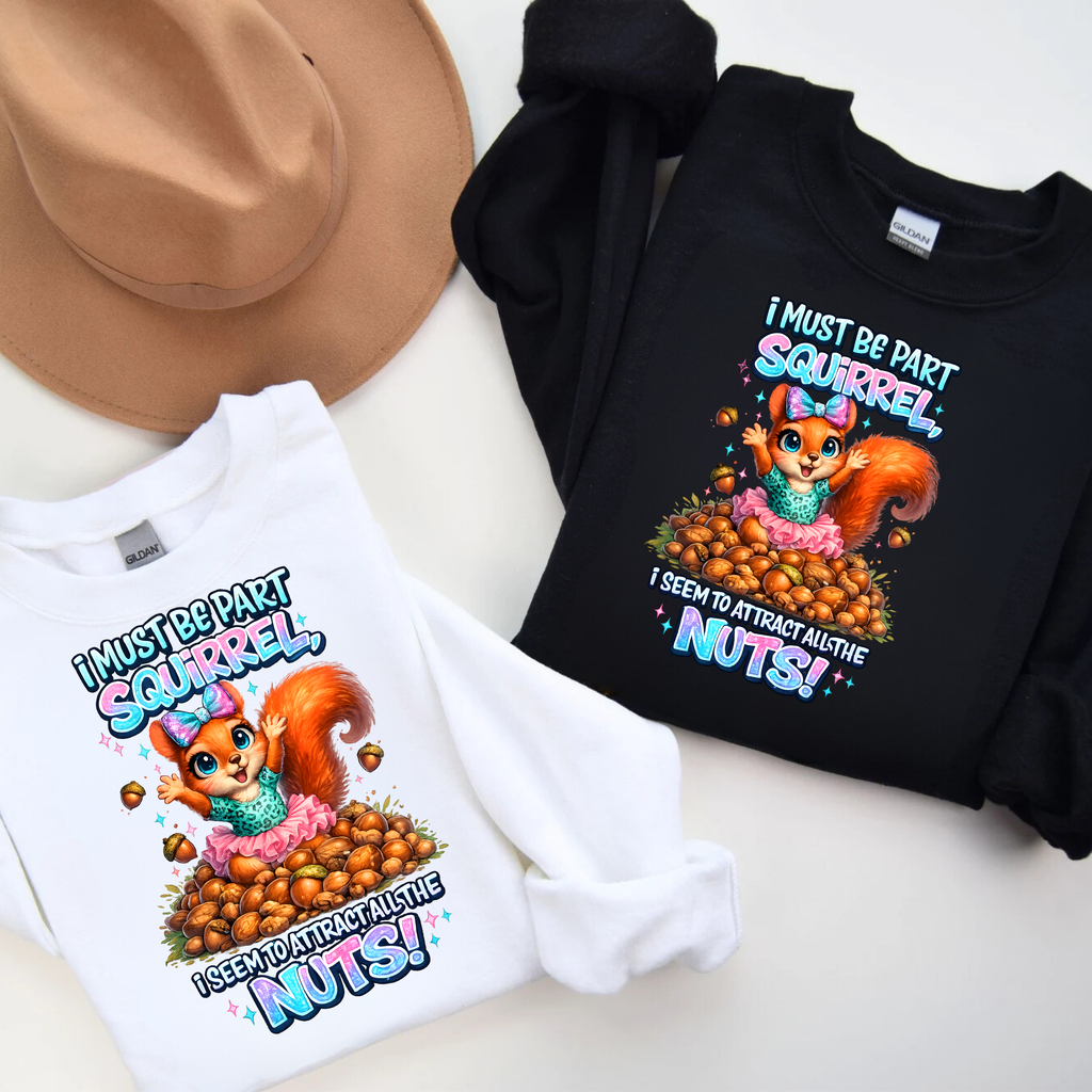 Two shirts with a cartoon squirrel design and text on a white surface.