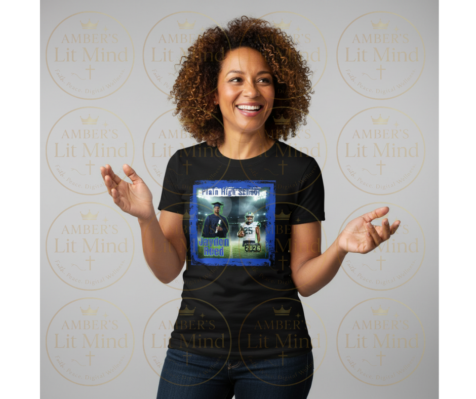 Woman wearing a black t-shirt with a graphic design, standing against a branded background.
