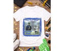 Graduation-themed t-shirt with personalized design on a wooden surface with graduation accessories.